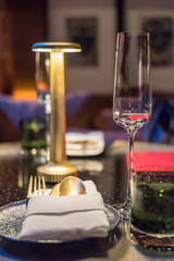 Champagne glass with plate and napkin on the table