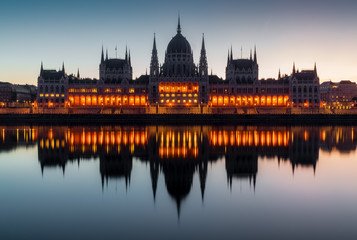 Fototapeta na wymiar Partly illuminated facade of Budapest Parliament during blue hour