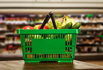 Green basket of food in shop interior and free space for your decoration. 
