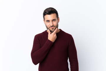 Young handsome man with beard over isolated white background thinking