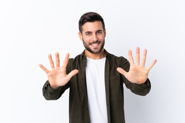 Young handsome man with beard over isolated white background counting ten with fingers
