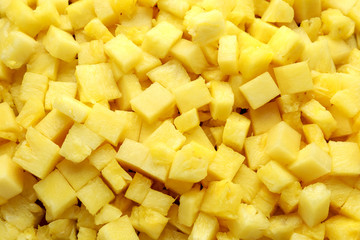 Fresh juicy pineapple slices with green leaves, tropical fruits background