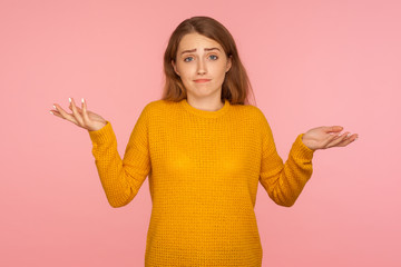 No idea, I don't know! Portrait of uncertain confused ginger girl in sweater expressing doubts and...