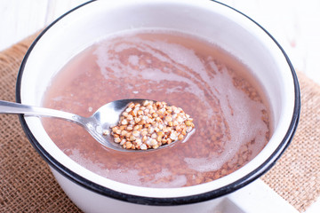 Green buckwheat in a spoon