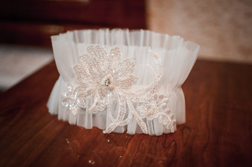 White wedding garter on the table