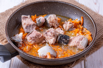 Sardines with vegetables in a pan