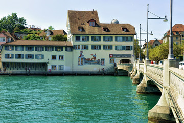 Zurich, Switzerland - September 2, 2016: Historical building with paintings at the Limmat River...