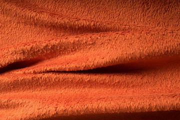 orange textile ,  wavy textile, warm colorful abstract background, orange fluffy blanket