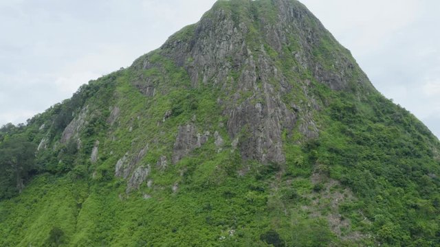 Beautiful aerial view of mountain peak with green trees in Jonggol, West Java, Indonsia. Shot in 4k resolution from a drone flying upwards
