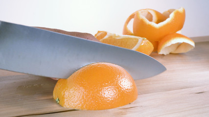 orange cutting in quarter with chefs knife