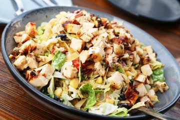 Chicken sriracha salad with strips of nacho chips