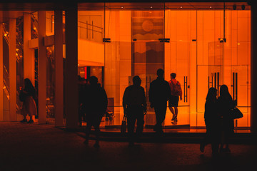 people leaving office building, silhouettes of  people