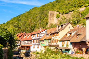 Fototapeta na wymiar ALSACE WINE REGION, FRANCE - SEP 20, 2019: Street with typical houses in Kaysersberg picturesque village which is located on Alsatian Wine Route, France.