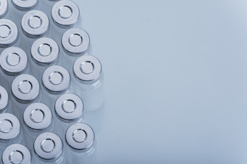 Glass medical ampoule vial for injection. Medicine is dry white drug penicillin powder or liquid with of aqueous solution in ampulla. Close up.