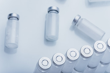 Glass medical ampoule vial for injection. Medicine is dry white drug penicillin powder or liquid with of aqueous solution in ampulla. Close up.