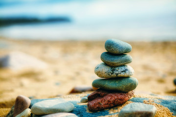 Sea pebble stones tower on beach. Balance and harmony concept