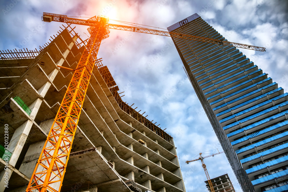 Wall mural construction site with cranes and buildings