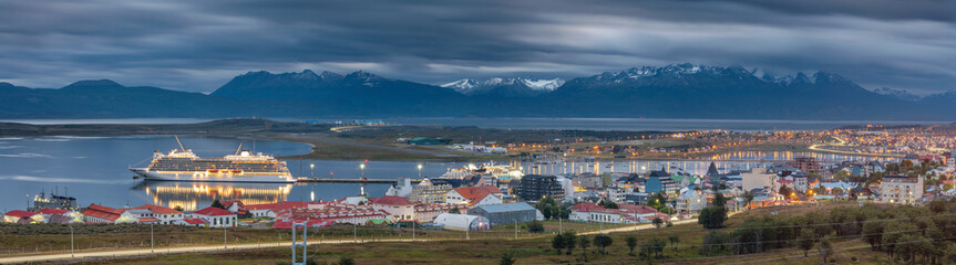 wide panorama of Ushuaia with view to cruise ship in harbor and mountains