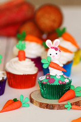 Fototapeta na wymiar Easter cupcakes baked with carrot decorated with small figures