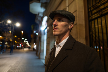 Old Fashion Man from the 1920s england walking along an old street of a historic city