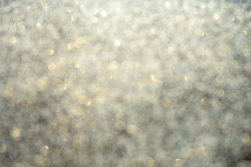 Defocused abstract beige lights background. Space. Wallpaper. Abstract glitter bokeh on black background