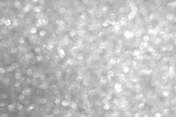 Defocused abstract gray lights background. Space. Wallpaper. Abstract glitter bokeh on black background