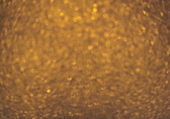 Defocused abstract gold, yellow, light brown lights background. Space. Wallpaper. Abstract glitter bokeh on black background