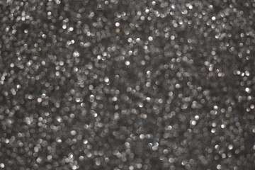 Defocused abstract gray lights background. Space. Wallpaper. Abstract glitter bokeh on black background