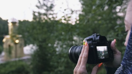 Traveler photographing scenic view in forest. One caucasian woman shooting nice magic look. Girl take photo video on dslr mirrorless camera. Professional photographer travel with backpack. Outdoor.