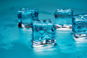 Ice cubes / Some clear melting ice cubes with drops around /close up