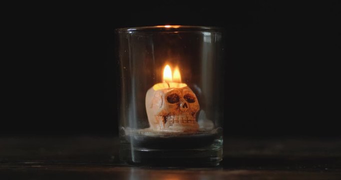 Dark background with candles and skull