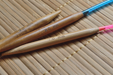 circular bamboo knitting needles on a wooden surface.