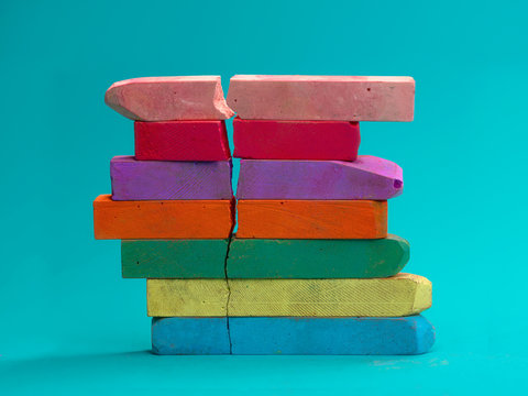 Stack of multi coloured chalk with a crack in