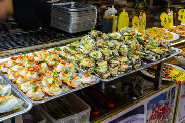Chinese street food. Street trading. Chinese kinds of fresh seafood at an asian seafood market in Sanya, Hainan province, China. Inscription: name food.