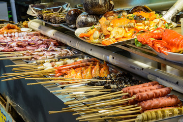 Chinese street food. Street trading. Chinese kinds of fresh seafood at an asian seafood market in Sanya, Hainan province, China. Inscription: name food.