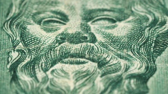 Socrates portrait on vintage Greece 500 drachma (1955) banknote rotating. Famous Ancient Greek philosopher, one of the founders of Western philosophy. Low angle, macro. 4K, 422 10 bit