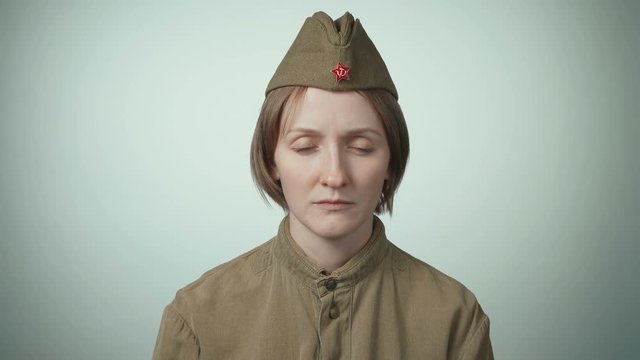 Video of young woman in soviet red army uniform on white