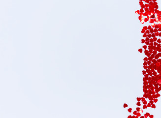 Background for Valentine's day from red sparkles in the shape of a heart on a white background with copy space for your text. Concept for valentines day. Flat lay, top view