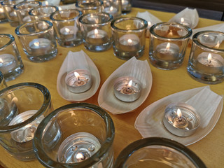 Candles in small glasses and boats during the vigil ceremony and prayer.