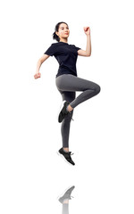 Obraz premium Full length portrait of fitness woman in sportswear jumping.