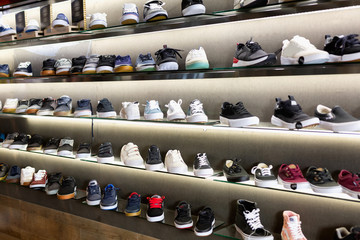 Variety of men and unisex sneakers in modern shoe shop
