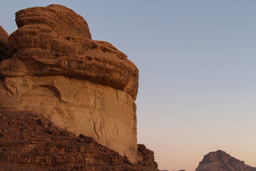 Textured sandstone mountain in Wadi Rum desert in Jordan after sunset. Beautiful landscape. Theme...