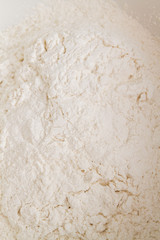Cooking dough in a white plastic bowl at home