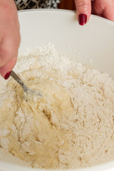 Cooking dough in a white plastic bowl at home