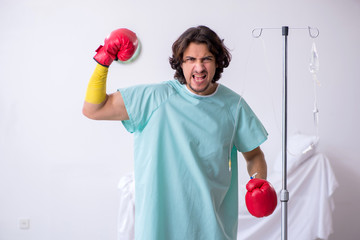 Young man staying in hospital in transfusion concept