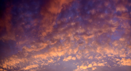 Obraz premium Clouds illuminated by the evening setting sun. Clouds at sunset day