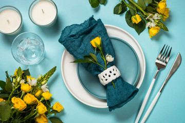 Spring table setting with flower top view.