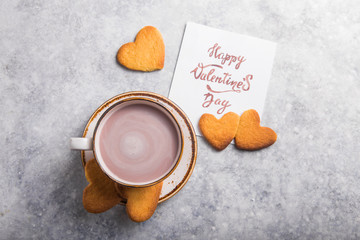 Cup of fresh morning coffee or cacao  with Valentine's day card, selective focus, horizontal, copy space.