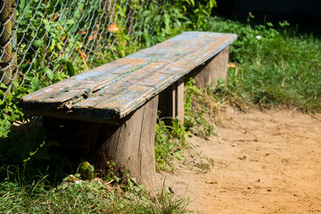 Old wooden bench with peeling blue paint