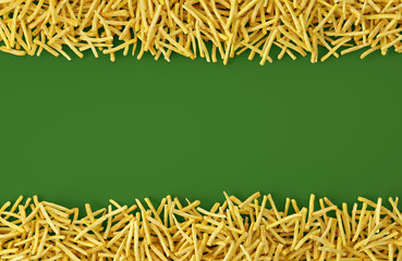 Fried potato chips arranged in stripes on green background. Top view of french fries. Flat lay fast food concept.